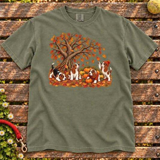 Four Basset Hound puppies with pumpkins beneath an autumn tree on a Moss garment-dyed T-shirt