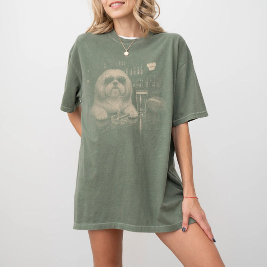 Model wearing a Moss Comfort Colors® T-shirt featuring Shih Tzu with beer and football graphics