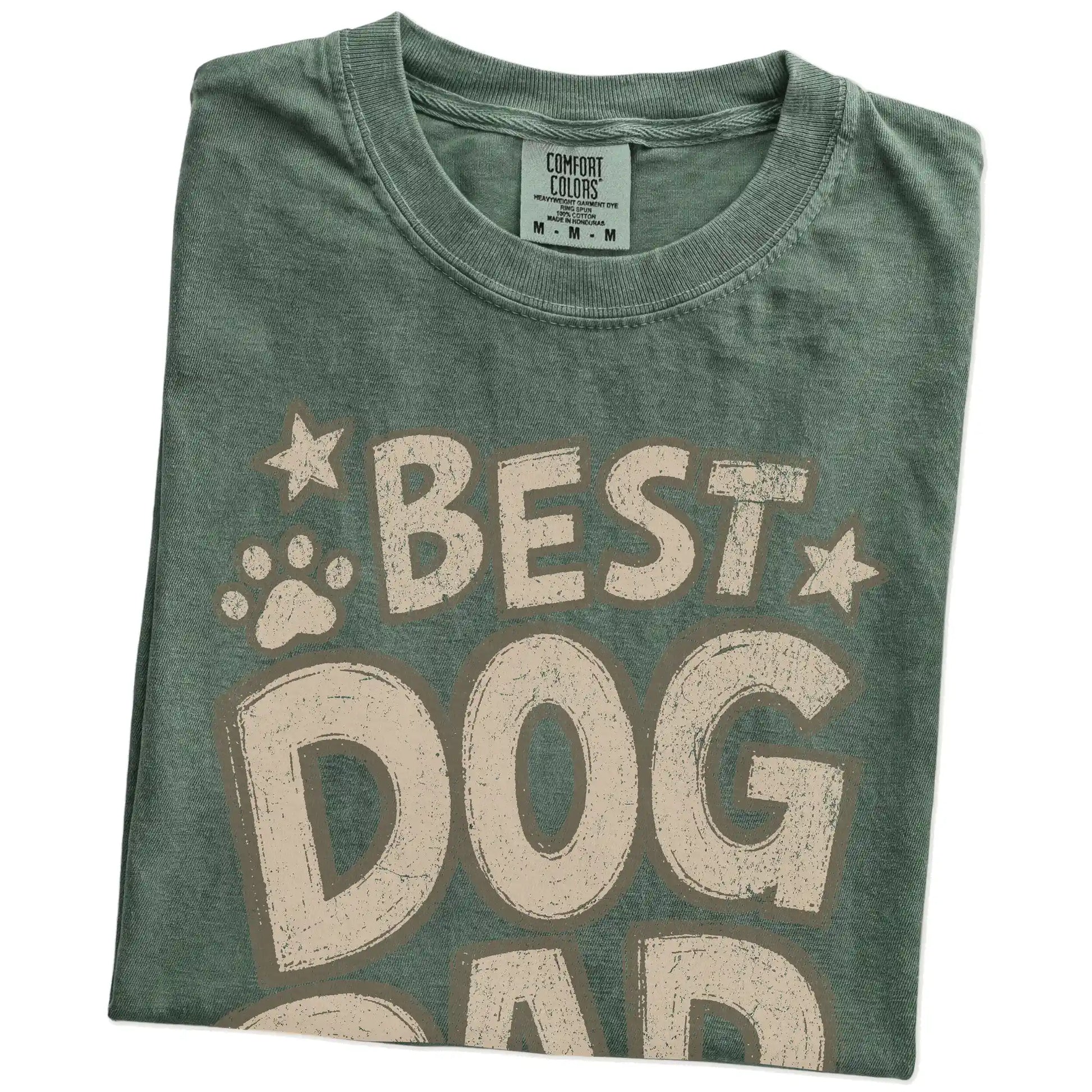 Folded Moss Comfort Colors® T-shirt showing best dog dad ever lettering