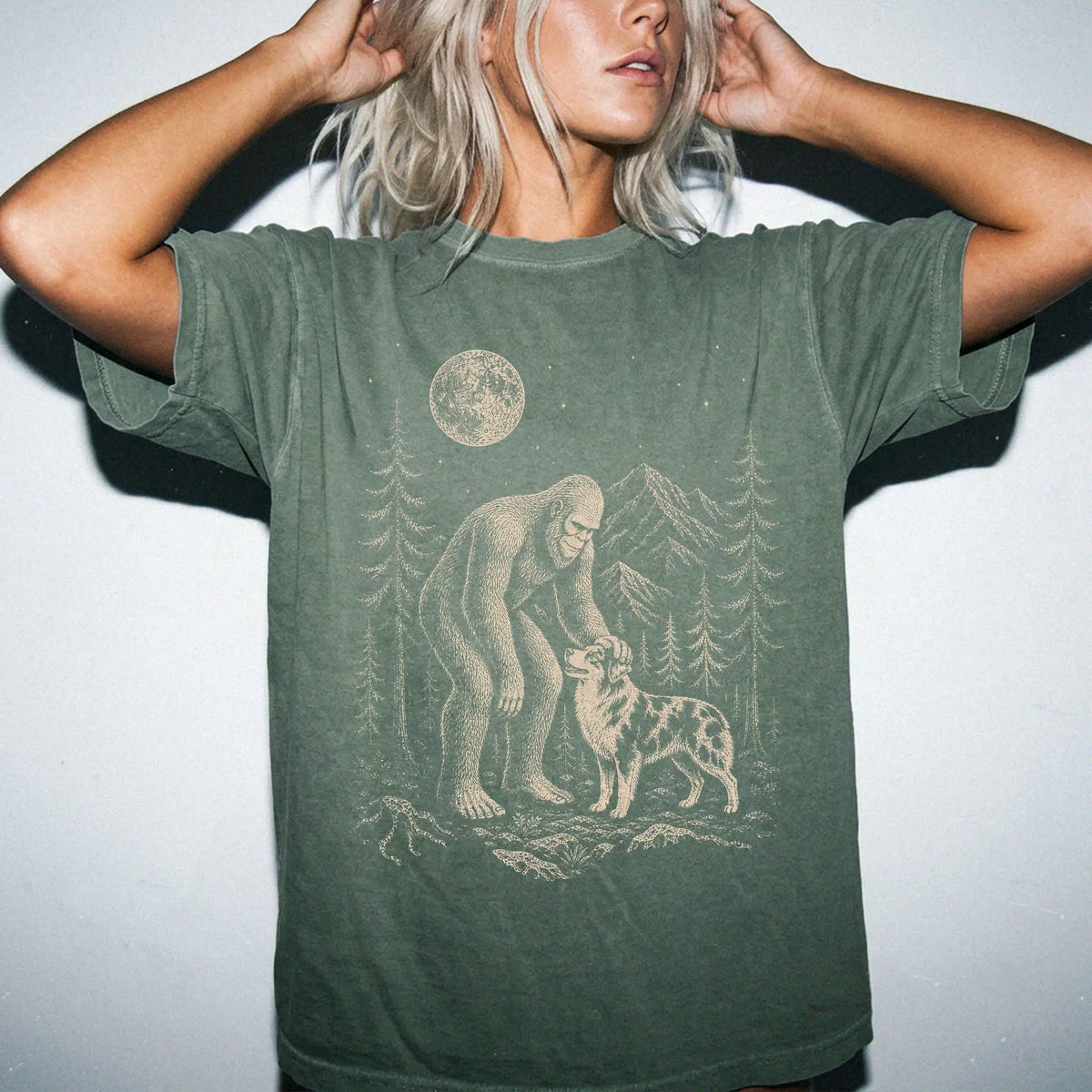 Person wearing the Australian Shepherd and Bigfoot T-Shirt in Moss