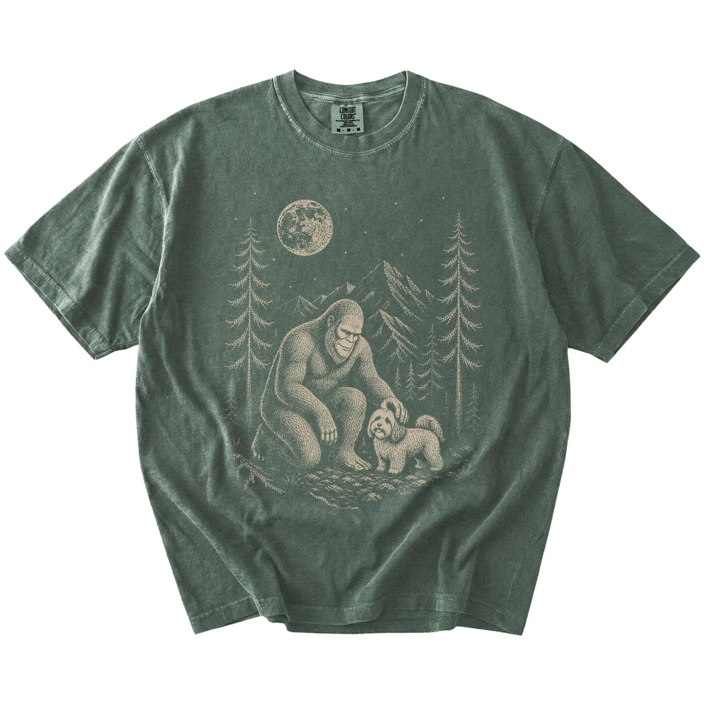 Bigfoot petting a Havanese beneath the moon in a pine forest on a Moss Comfort Colors® T-shirt
