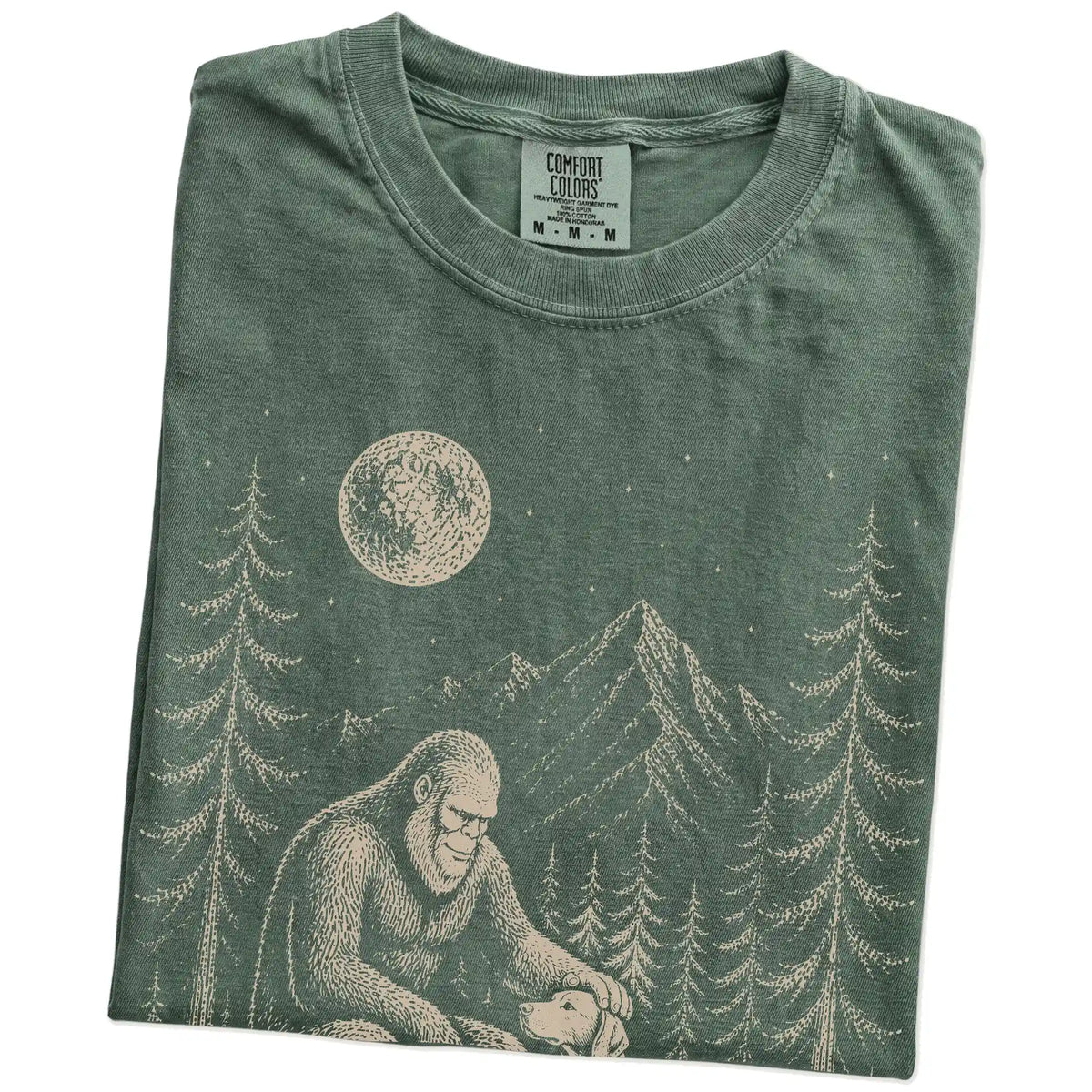 Folded Moss Comfort Colors® T-shirt showing bigfoot petting a vizsla beneath the moon in a pine forest