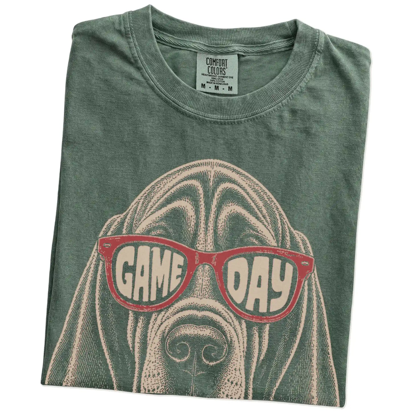 Folded Moss Comfort Colors® T-shirt showing bloodhound wearing red game day sunglasses