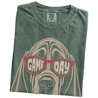 Folded Moss Comfort Colors® T-shirt showing bloodhound wearing red game day sunglasses