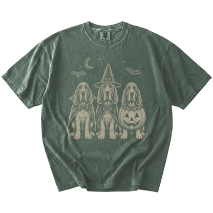 Three Bloodhound dogs dressed for Halloween beneath bats and a crescent moon on a Moss Comfort Colors® T-shirt