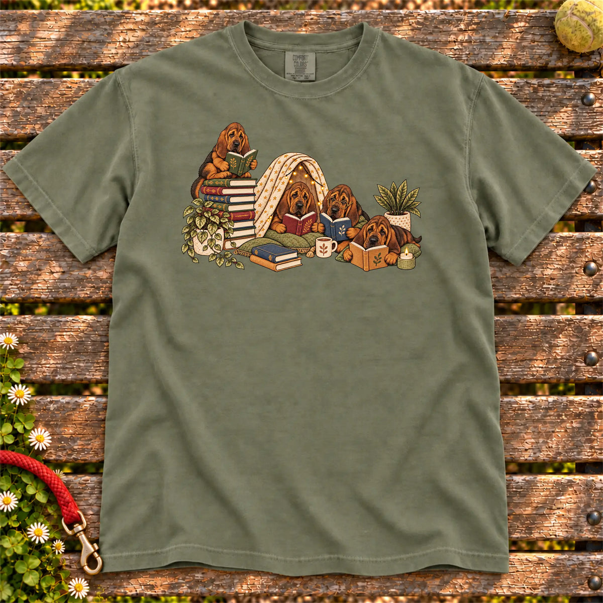 Bloodhound puppies reading books in a cozy blanket fort on a Moss T-shirt