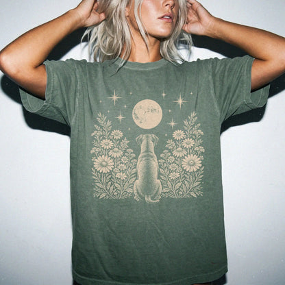 Model wearing a Moss Comfort Colors® T-shirt featuring Boxer beneath a wildflower moon