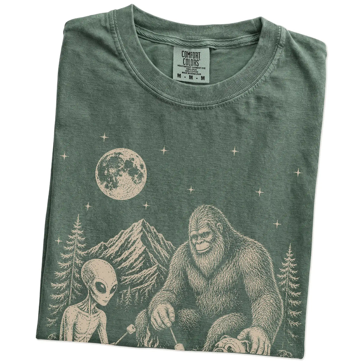 Folded Moss Comfort Colors® T-shirt showing Bulldog camping with Bigfoot and an alien