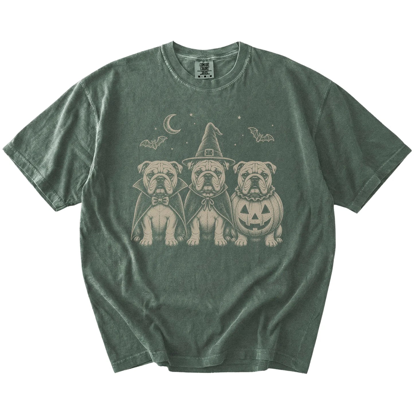 Three Bulldog dogs dressed for Halloween beneath bats and a crescent moon on a Moss Comfort Colors® T-shirt