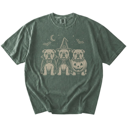 Three Bulldog dogs dressed for Halloween beneath bats and a crescent moon on a Moss Comfort Colors® T-shirt