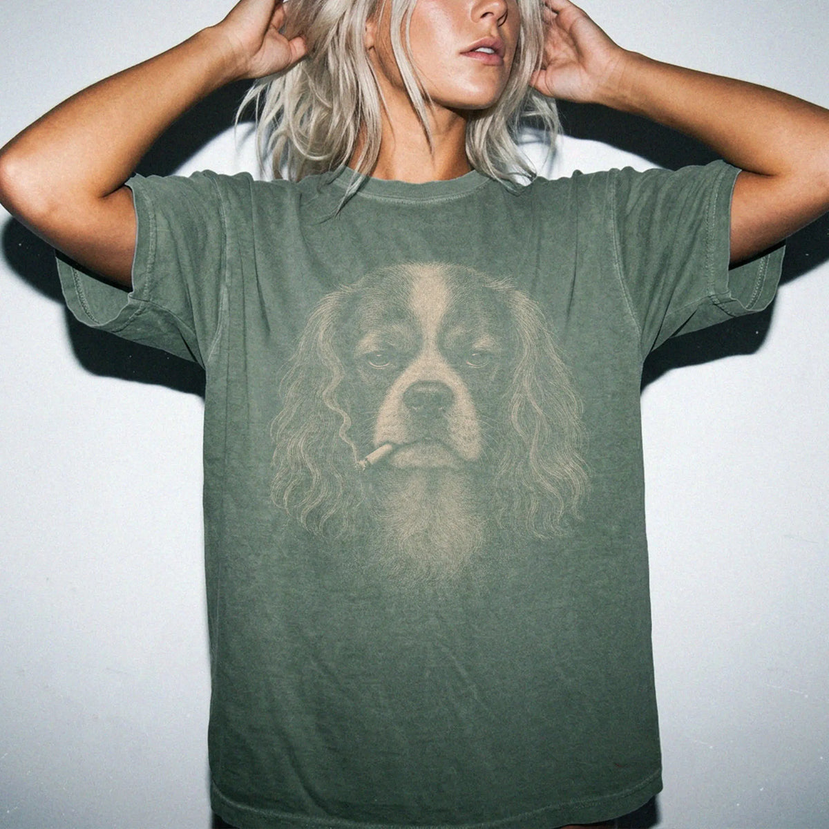 Model wearing a Cavalier King Charles Spaniel smoking design on a Moss t-shirt