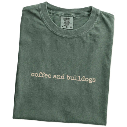 Folded Moss Comfort Colors® T-shirt showing “coffee and bulldogs” retro text