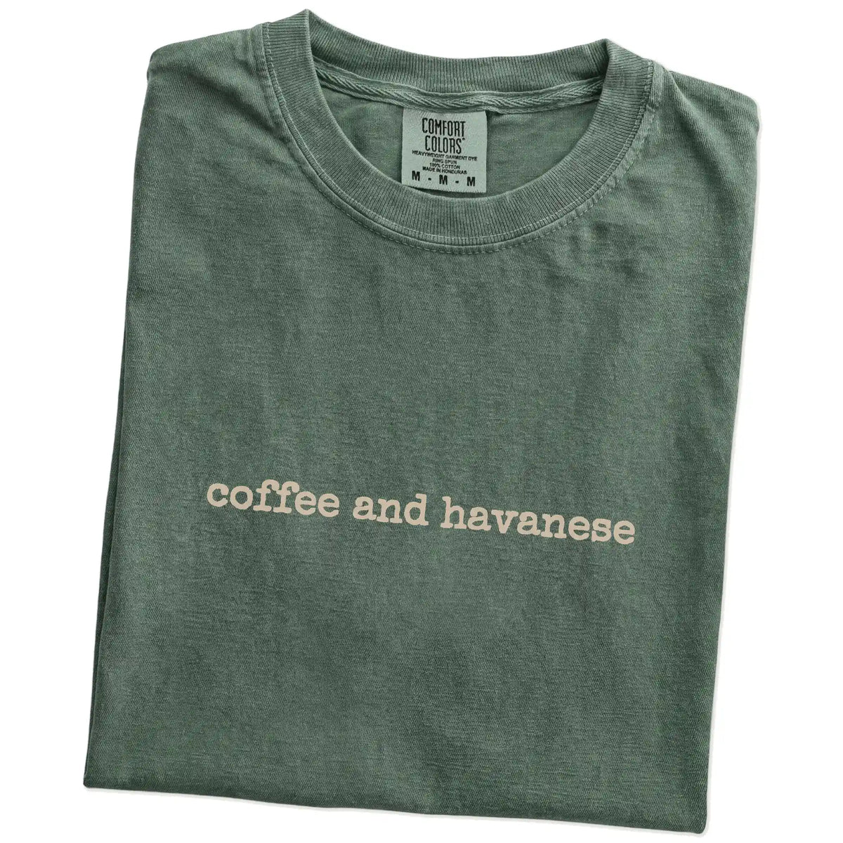 Folded Moss Comfort Colors® T-shirt showing “coffee and havanese” retro text