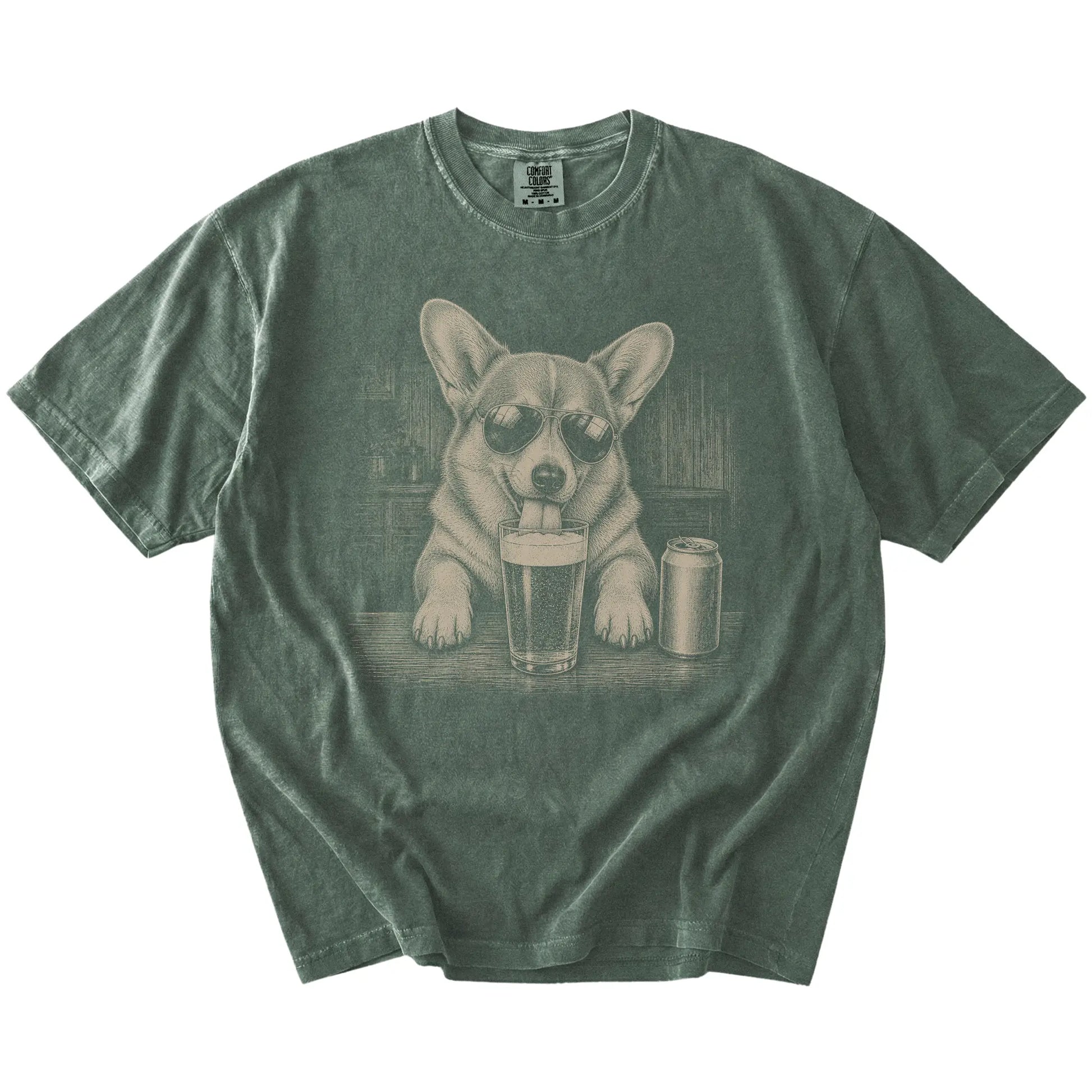 Corgi sneaking a drink from a foamy pint at home on a Moss Comfort Colors® t-shirt