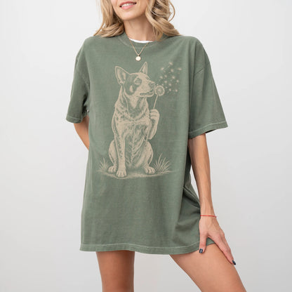 Model wearing a Moss Comfort Colors® T-shirt showing Blue Heeler portrait with drifting dandelion seeds