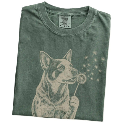 Folded Moss Comfort Colors® T-shirt showing Blue Heeler portrait with drifting dandelion seeds