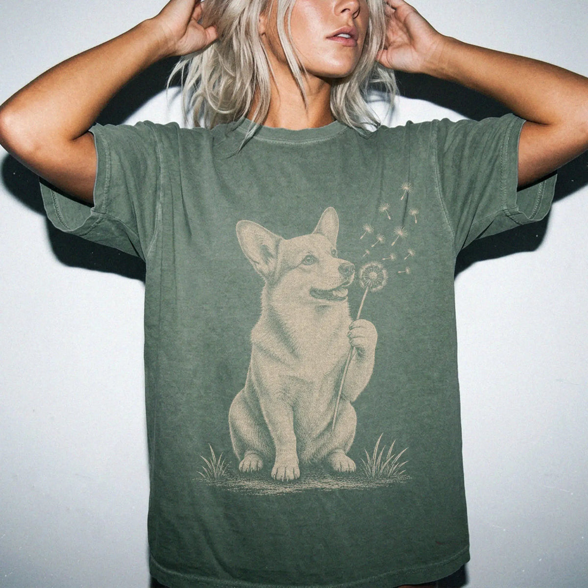 Model wearing a Moss Comfort Colors® T-shirt showing Corgi portrait with drifting dandelion seeds
