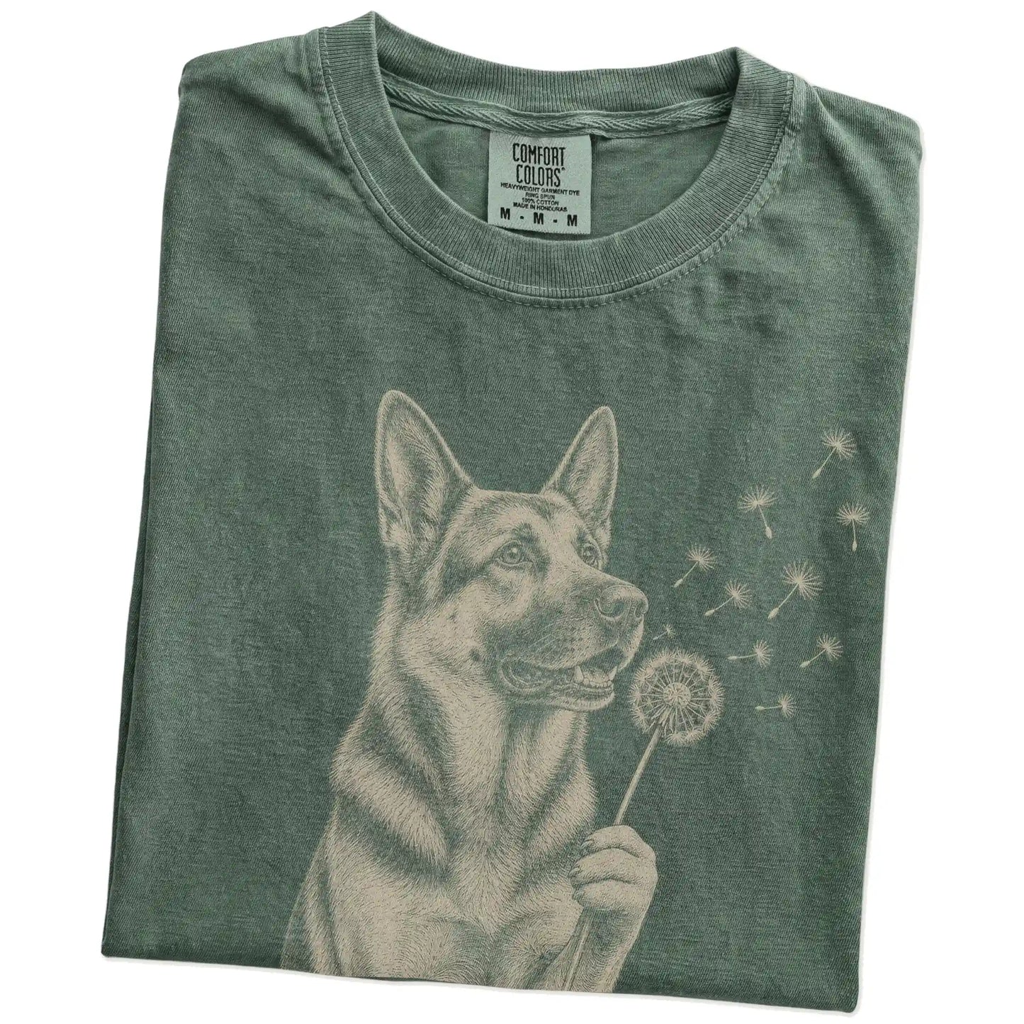Folded Moss Comfort Colors® T-shirt showing German Shepherd portrait with drifting dandelion seeds