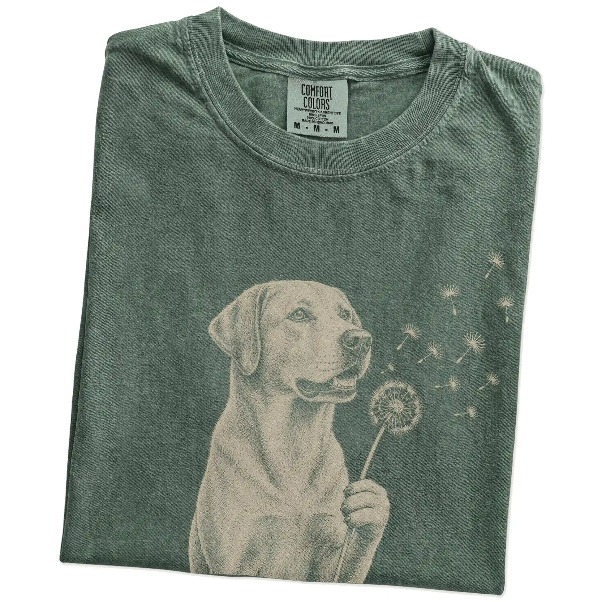 Folded Moss Comfort Colors® T-shirt showing Labrador Retriever portrait with drifting dandelion seeds