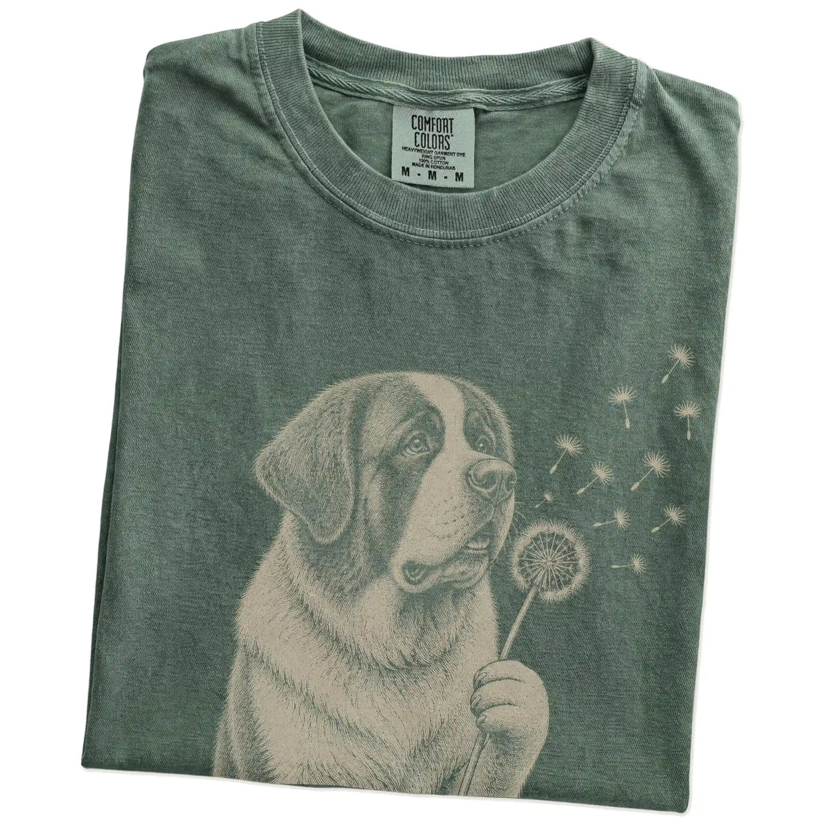 Folded Moss Comfort Colors® T-shirt showing Saint Bernard portrait with drifting dandelion seeds