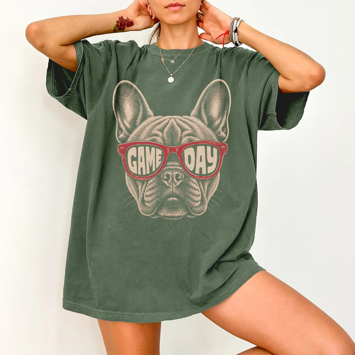 Model wearing a Moss Comfort Colors® T-shirt with french bulldog wearing red game day sunglasses
