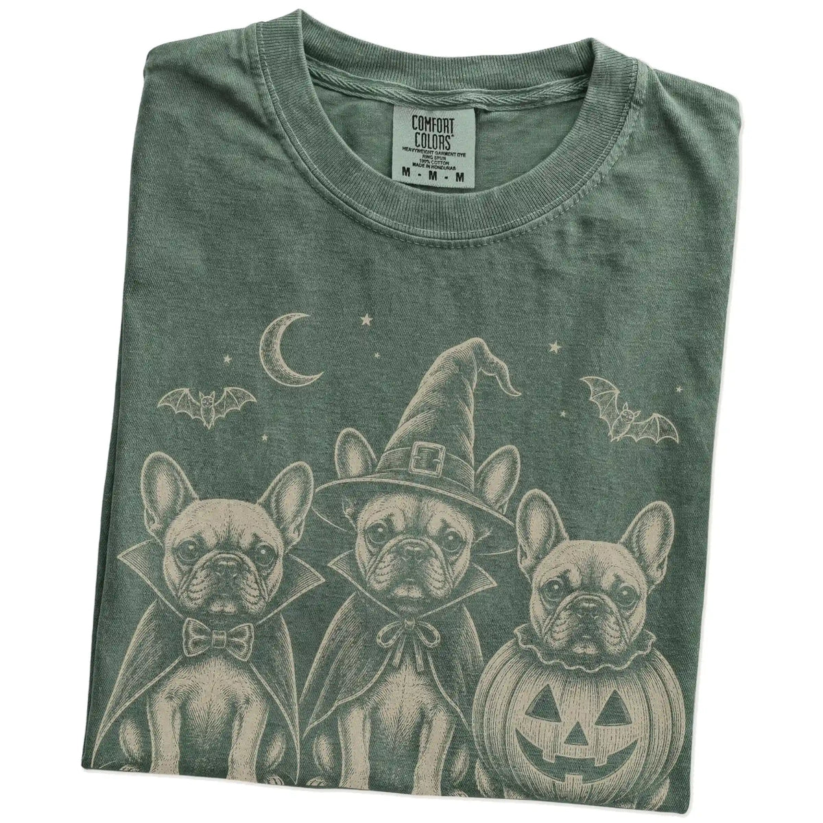 Folded Moss Comfort Colors® T-shirt showing three French Bulldog dogs dressed for Halloween beneath bats and a crescent moon