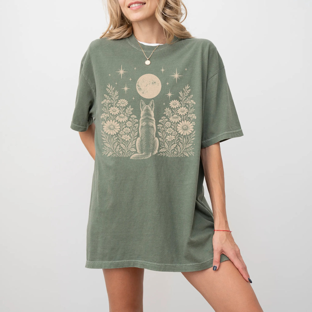 Model wearing a Moss Comfort Colors® T-shirt featuring German Shepherd beneath a wildflower moon