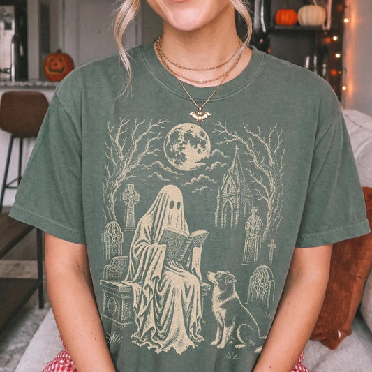 Model wearing a Moss Comfort Colors® T-shirt showing Border Collie beside a reading ghost in a moonlit graveyard