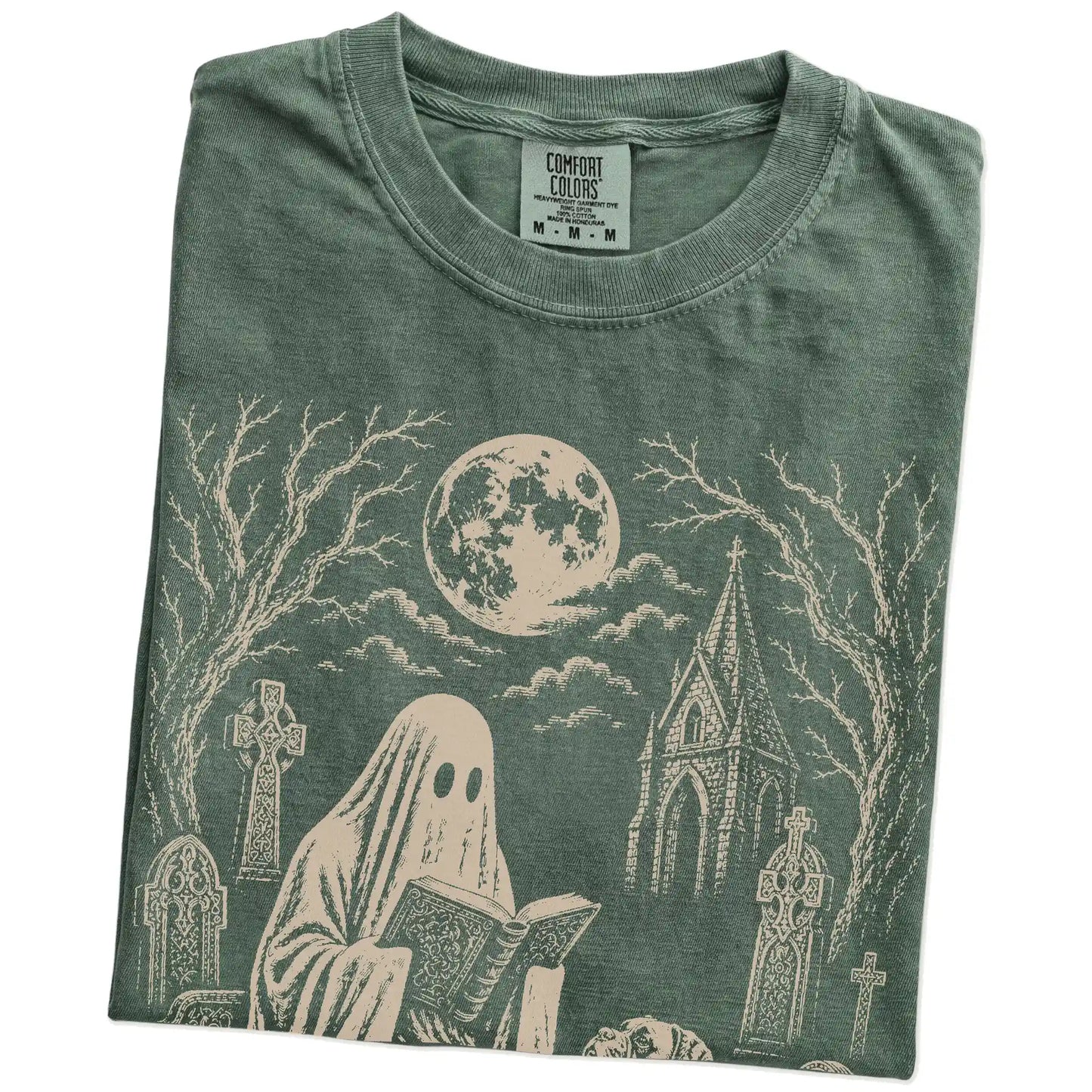 Folded Moss Comfort Colors® T-shirt showing Boxer beside a reading ghost in a moonlit graveyard