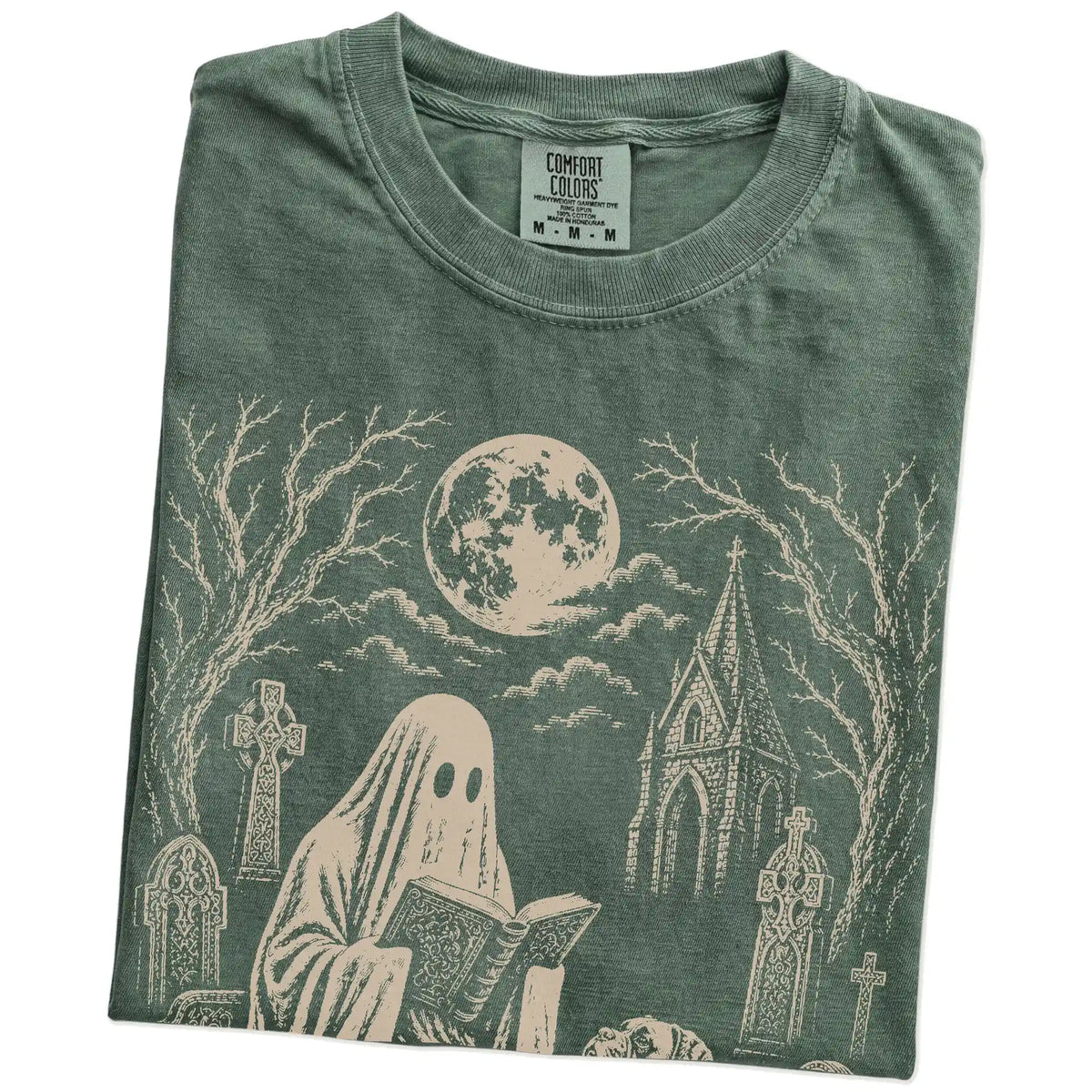 Folded Moss Comfort Colors® T-shirt showing Boxer beside a reading ghost in a moonlit graveyard