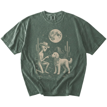 Cowboy alien fist-bumping a Goldendoodle beneath the moon on a Moss Comfort Colors® T-shirt