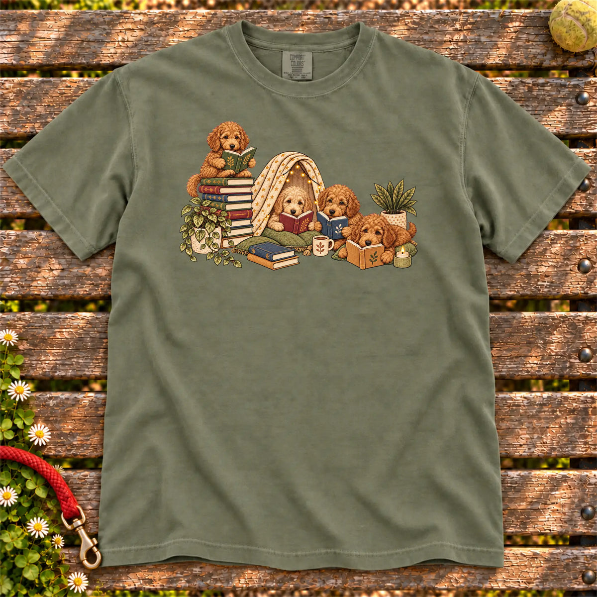 Goldendoodle puppies reading books in a cozy blanket fort on a Moss T-shirt