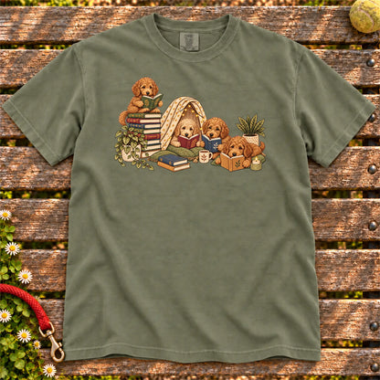Goldendoodle puppies reading books in a cozy blanket fort on a Moss T-shirt