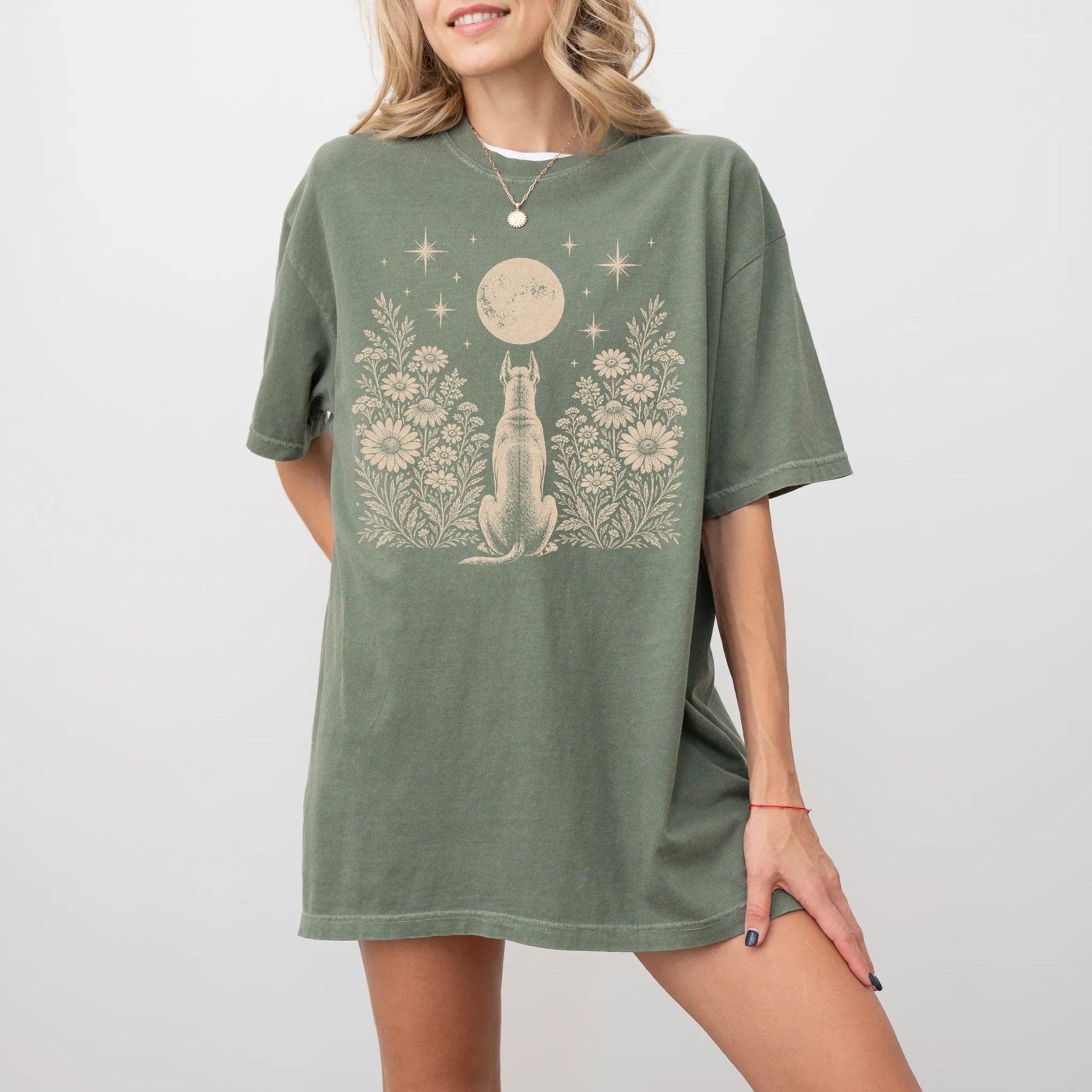 Model wearing a Moss Comfort Colors® T-shirt featuring Great Dane beneath a wildflower moon