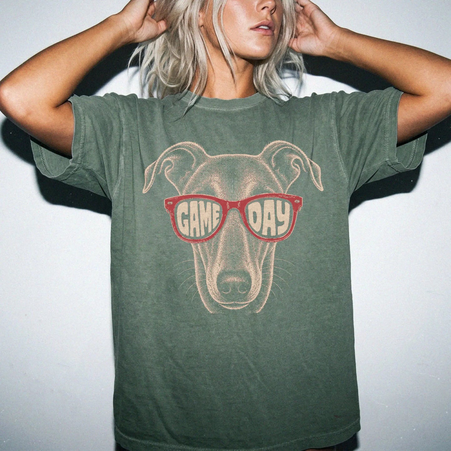 Model wearing a Moss Comfort Colors® T-shirt with greyhound wearing red game day sunglasses