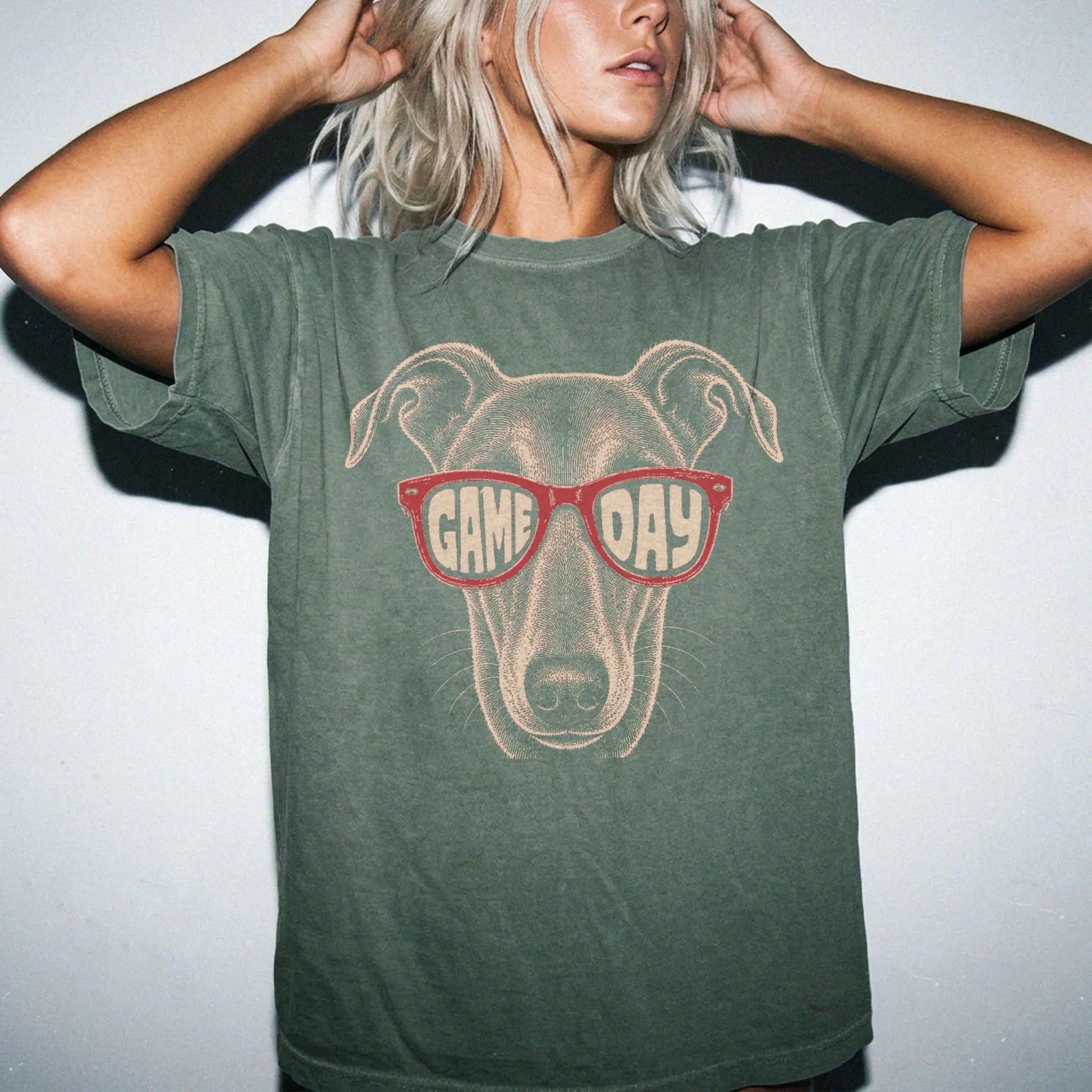 Model wearing a Moss Comfort Colors® T-shirt with greyhound wearing red game day sunglasses