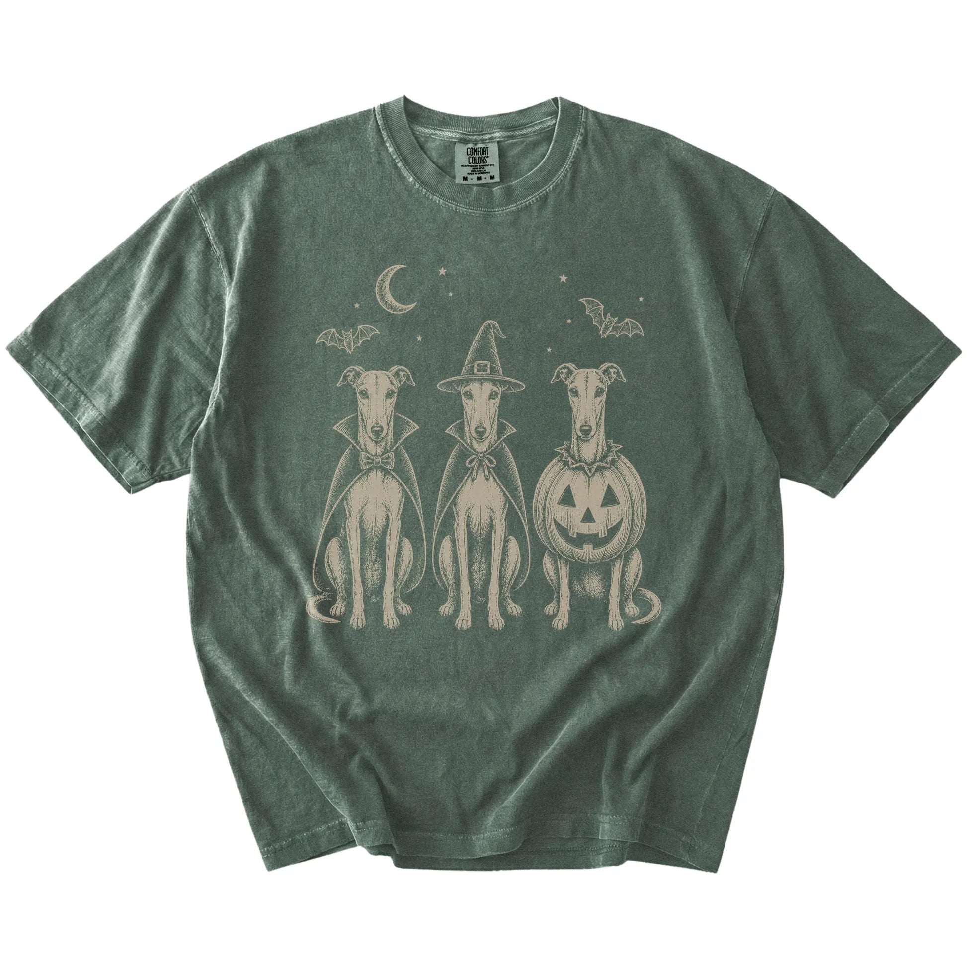 Three Greyhound dogs dressed for Halloween beneath bats and a crescent moon on a Moss Comfort Colors® T-shirt