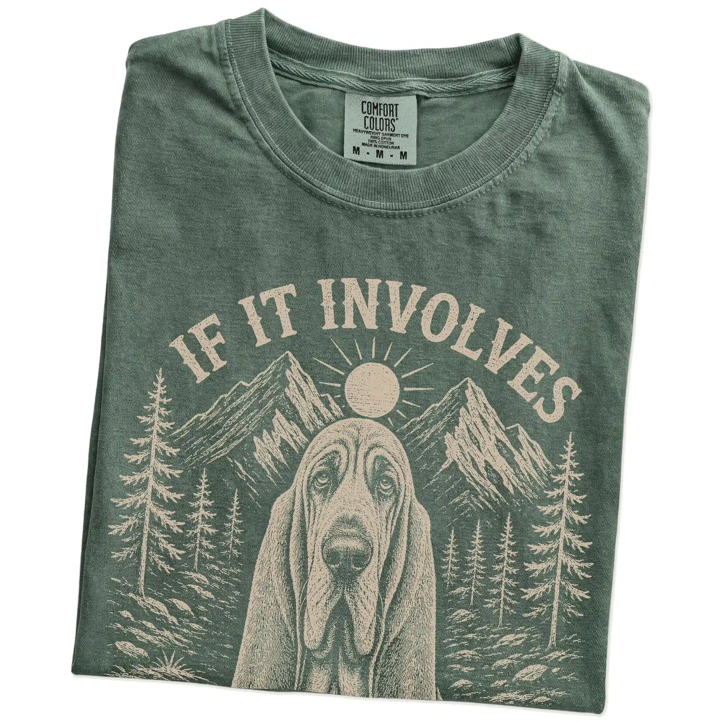 Folded Moss Comfort Colors® T-shirt showing Bloodhound hiking design with mountain scenery