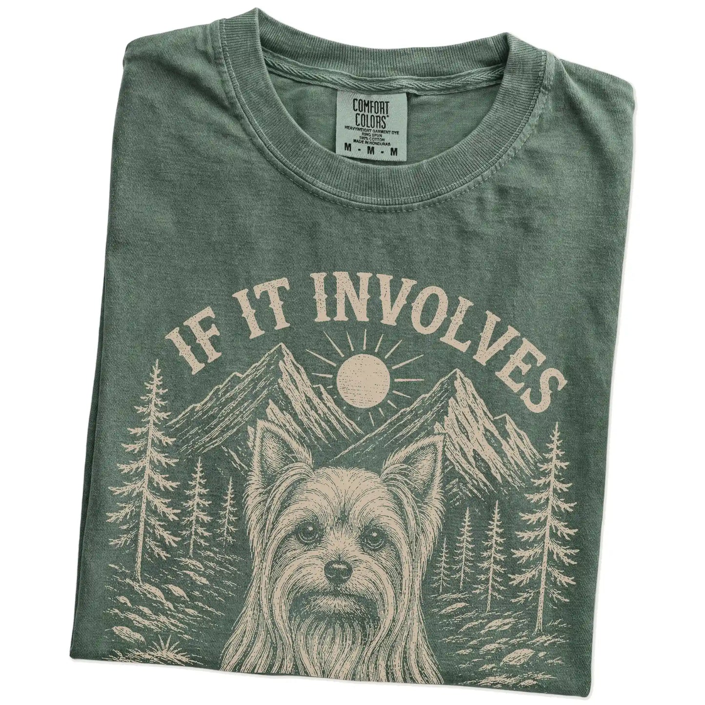 Folded Moss Comfort Colors® T-shirt showing Yorkie hiking design with mountain scenery