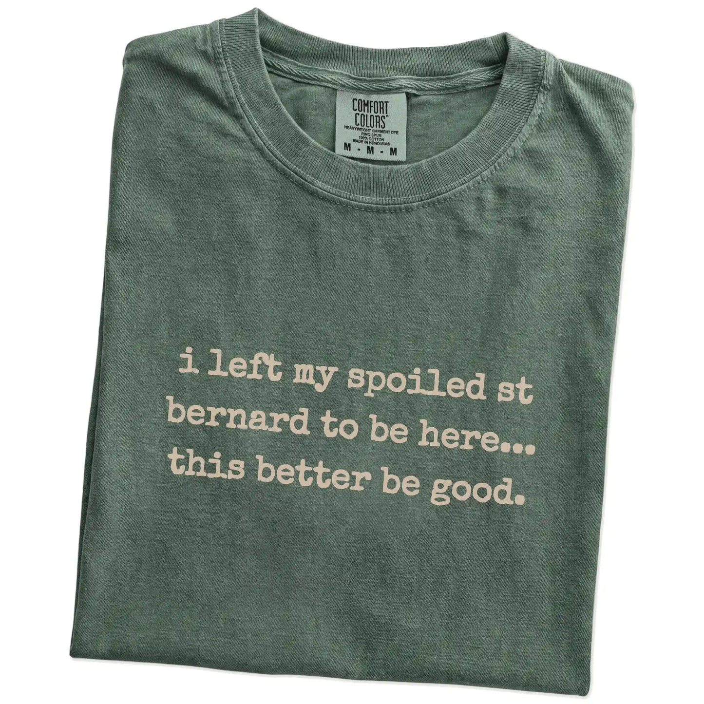 Folded Moss Comfort Colors® T-shirt showing the “I Left My Spoiled Saint Bernard Home” saying