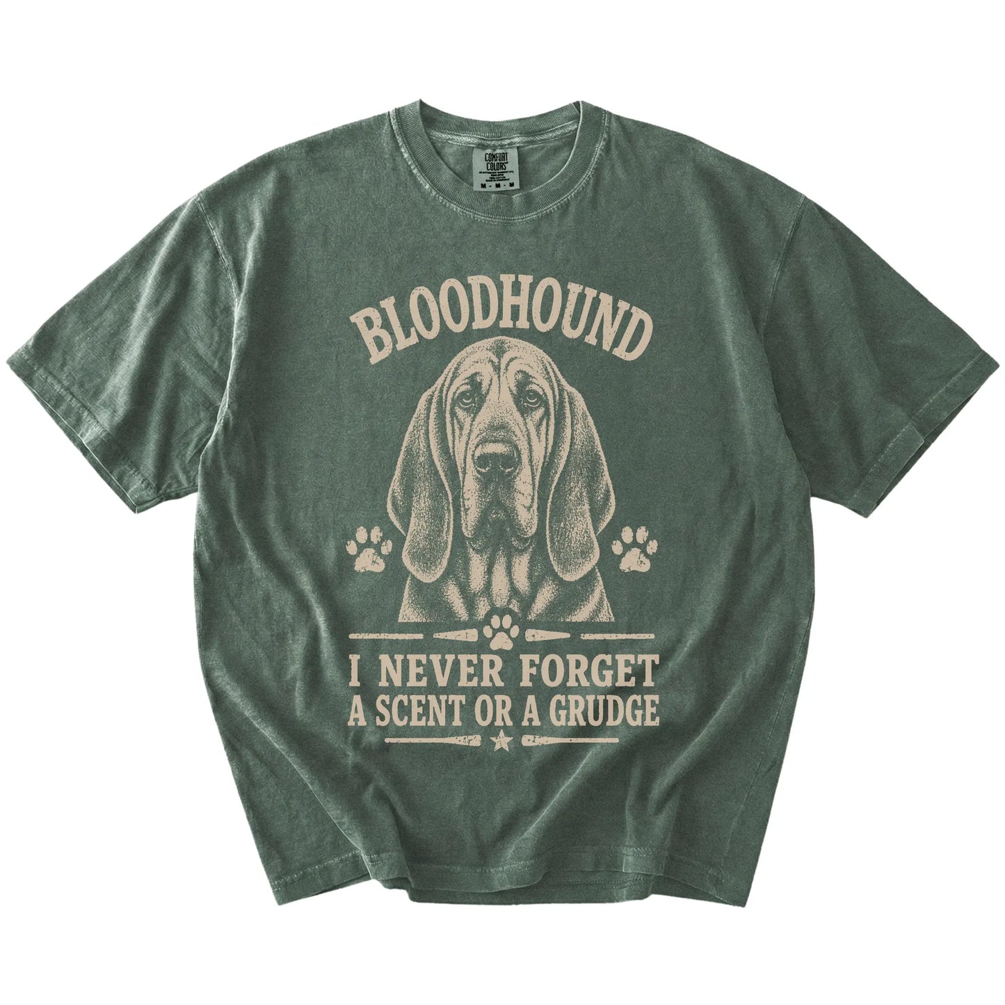 Bloodhound design with “I Never Forget A Scent Or A Grudge” lettering on a Moss Comfort Colors® T-shirt