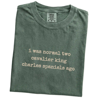 Folded Moss Comfort Colors® T-shirt showing i was normal two cavalier king charles spaniels ago lettering