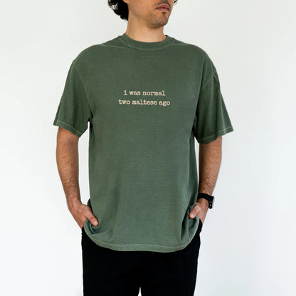 Model wearing a Moss Comfort Colors® T-shirt with i was normal two maltese ago lettering