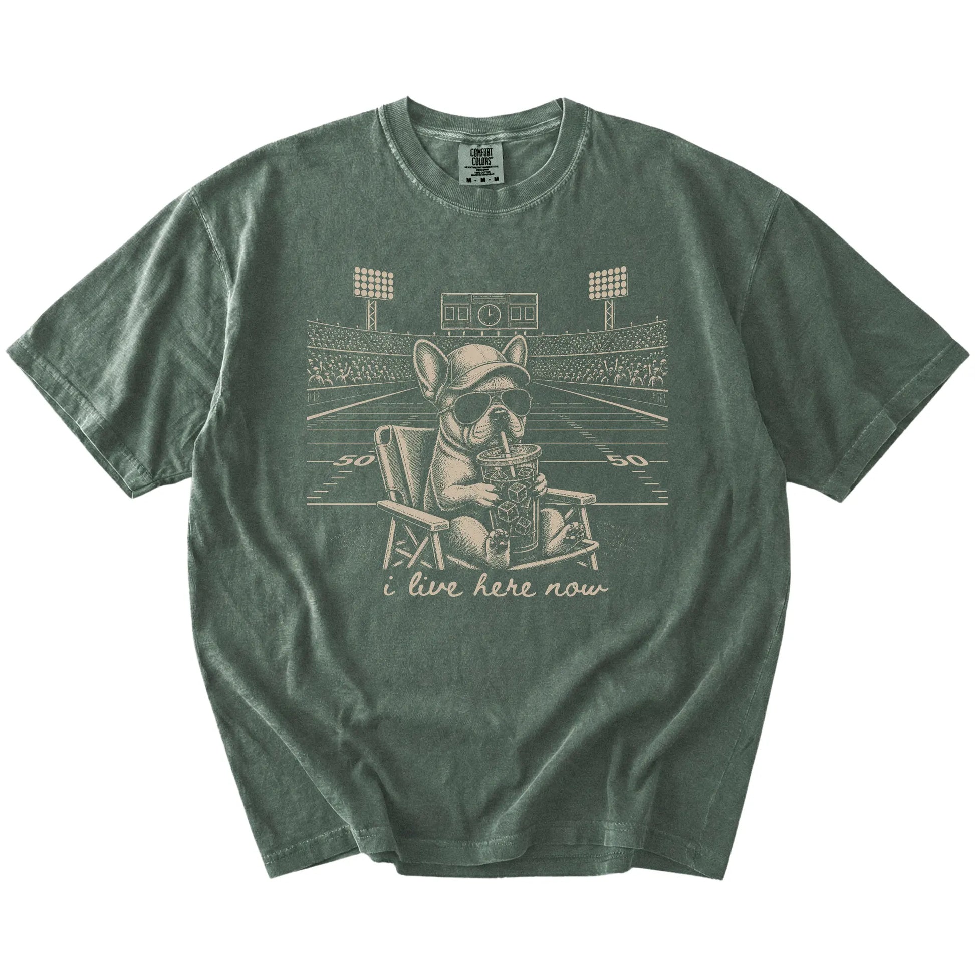 French Bulldog claiming the football field with “I Live Here Now” lettering on a Moss Comfort Colors® T-shirt