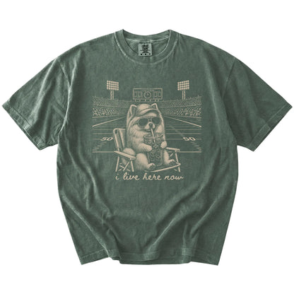Pomeranian claiming the football field with “I Live Here Now” lettering on a Moss Comfort Colors® T-shirt