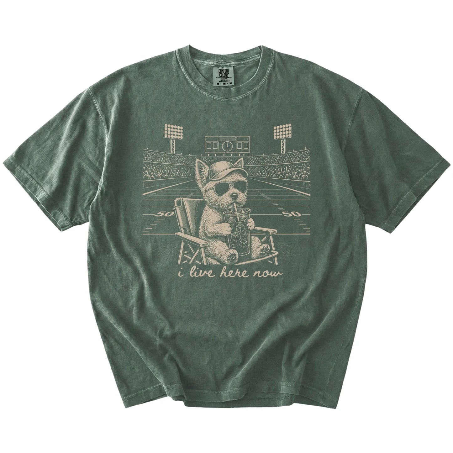 Westie claiming the football field with “I Live Here Now” lettering on a Moss Comfort Colors® T-shirt