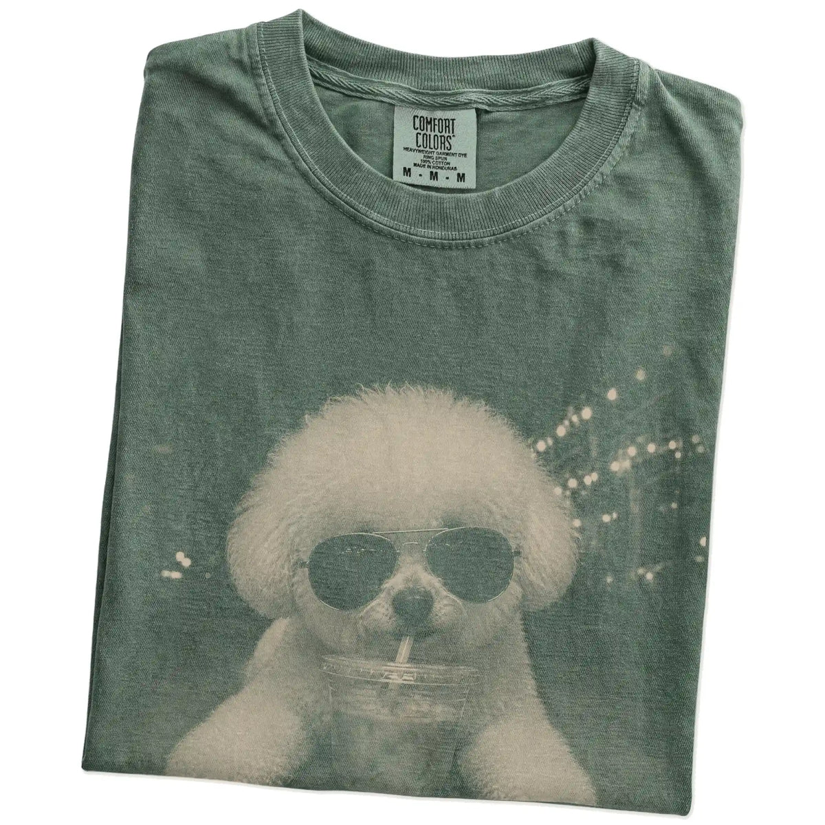 Folded Moss Comfort Colors® T-shirt showing Bichon Frise with iced coffee in a retro grunge design