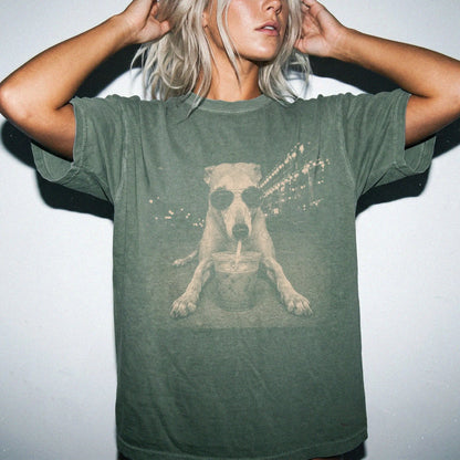 Model wearing a Moss Comfort Colors® T-shirt featuring Greyhound with iced coffee in a retro grunge design