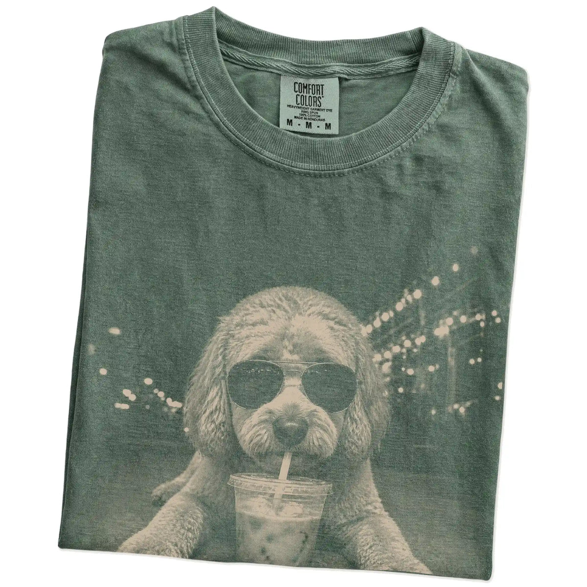 Folded Moss Comfort Colors® T-shirt showing Labradoodle with iced coffee in a retro grunge design