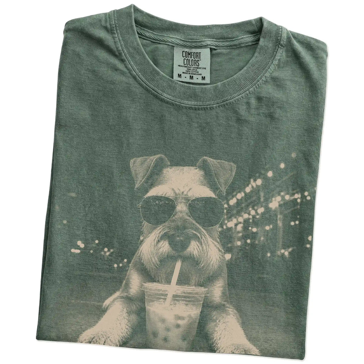 Folded Moss Comfort Colors® T-shirt showing Schnauzer with iced coffee in a retro grunge design